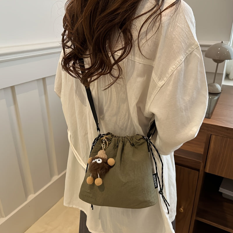Lightweight Nylon Crossbody Bucket Bag – Large Capacity Drawstring Shoulder Bag with Pendant Charm, Sporty Casual