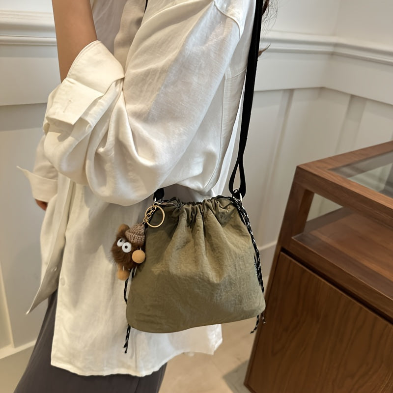 Lightweight Nylon Crossbody Bucket Bag – Large Capacity Drawstring Shoulder Bag with Pendant Charm, Sporty Casual