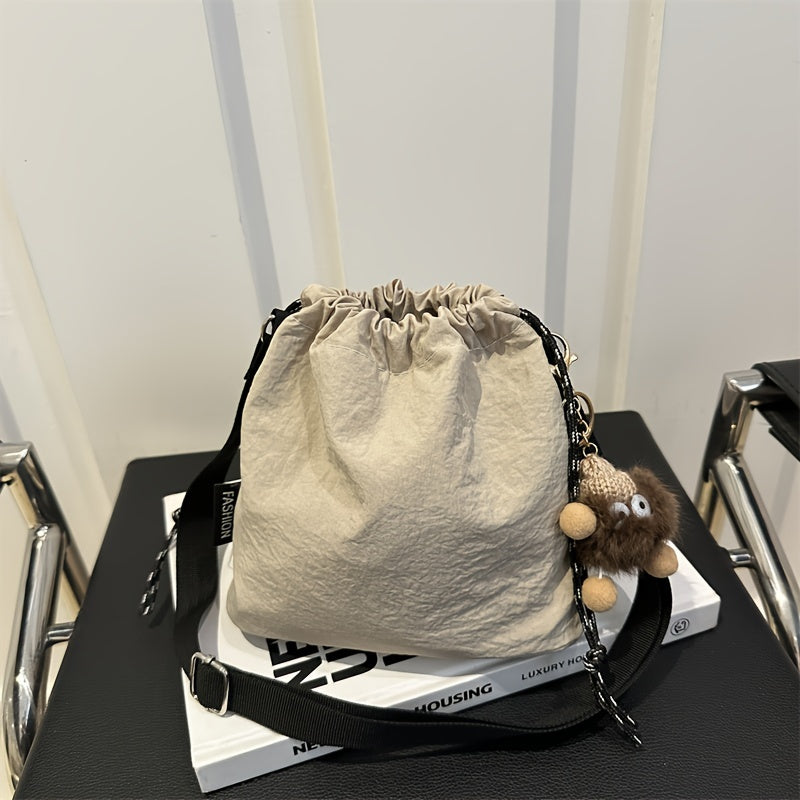 Lightweight Nylon Crossbody Bucket Bag – Large Capacity Drawstring Shoulder Bag with Pendant Charm, Sporty Casual